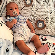 Noah is registered to the contest to win money with this photo: baby, pacifier, blanket, crochet, pattern, animal_print, infant, clothing, comfort, cute, child, toddler, indoors, soft_toys, relaxed, foot, hand, person, portrait, resting