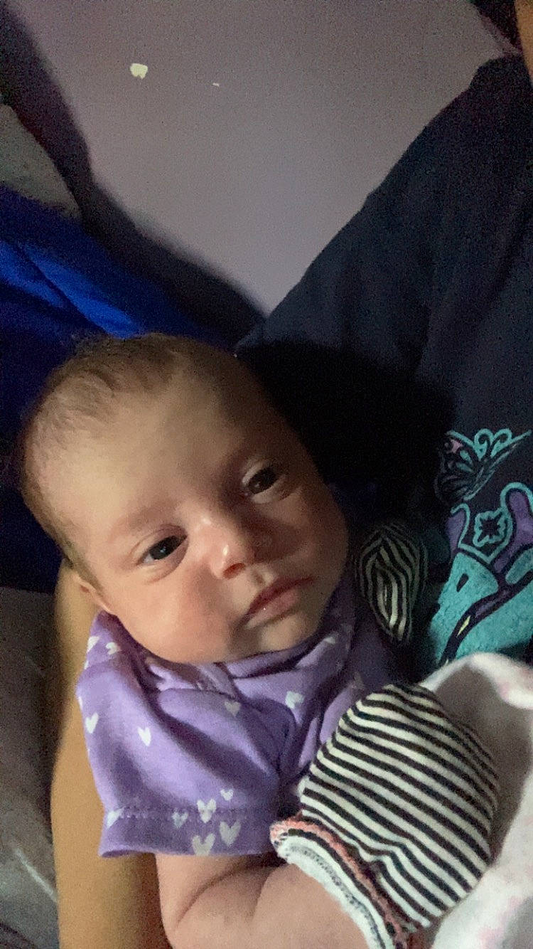 Essence is registered to the contest to win money with this photo: baby, baby_toddler_clothing, cheek, child, chin, comfort, ear, eye, eyebrow, face, happy, head, iris, linens, mouth, nose, person, sitting, skin, sleeve