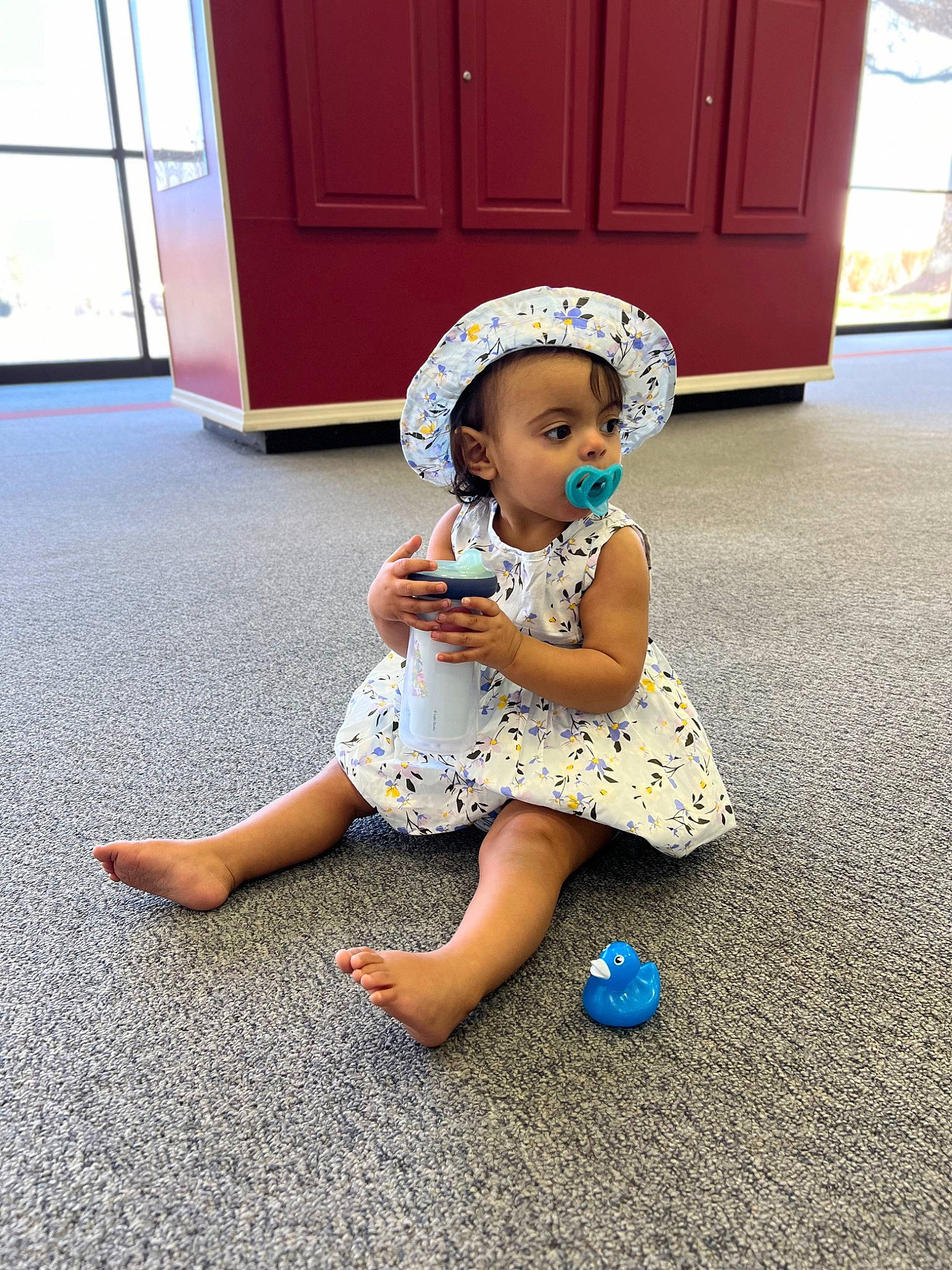 Magnolia is registered to the contest to win money with this photo: asphalt, baby_toddler_clothing, electric_blue, floor, flooring, foot, fun, happy, hat, human_leg, knee, leisure, line, person, sandal, shoe, sneakers, standing, sun_hat, thigh