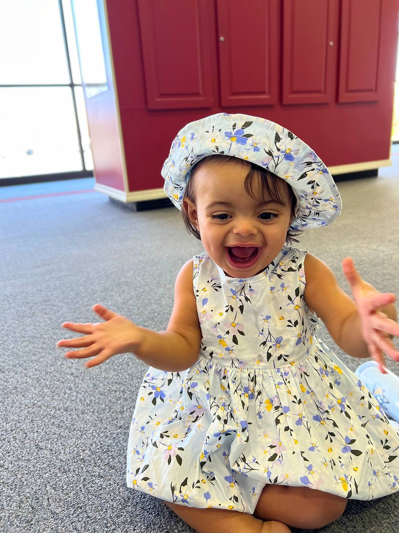 Magnolia is registered to the contest to win money with this photo: baby, baby_toddler_clothing, blue, cabinetry, child, day_dress, dress, face, facial_expression, fun, happy, hat, joy, person, photograph, pink, skin, sleeve, smile, toddler