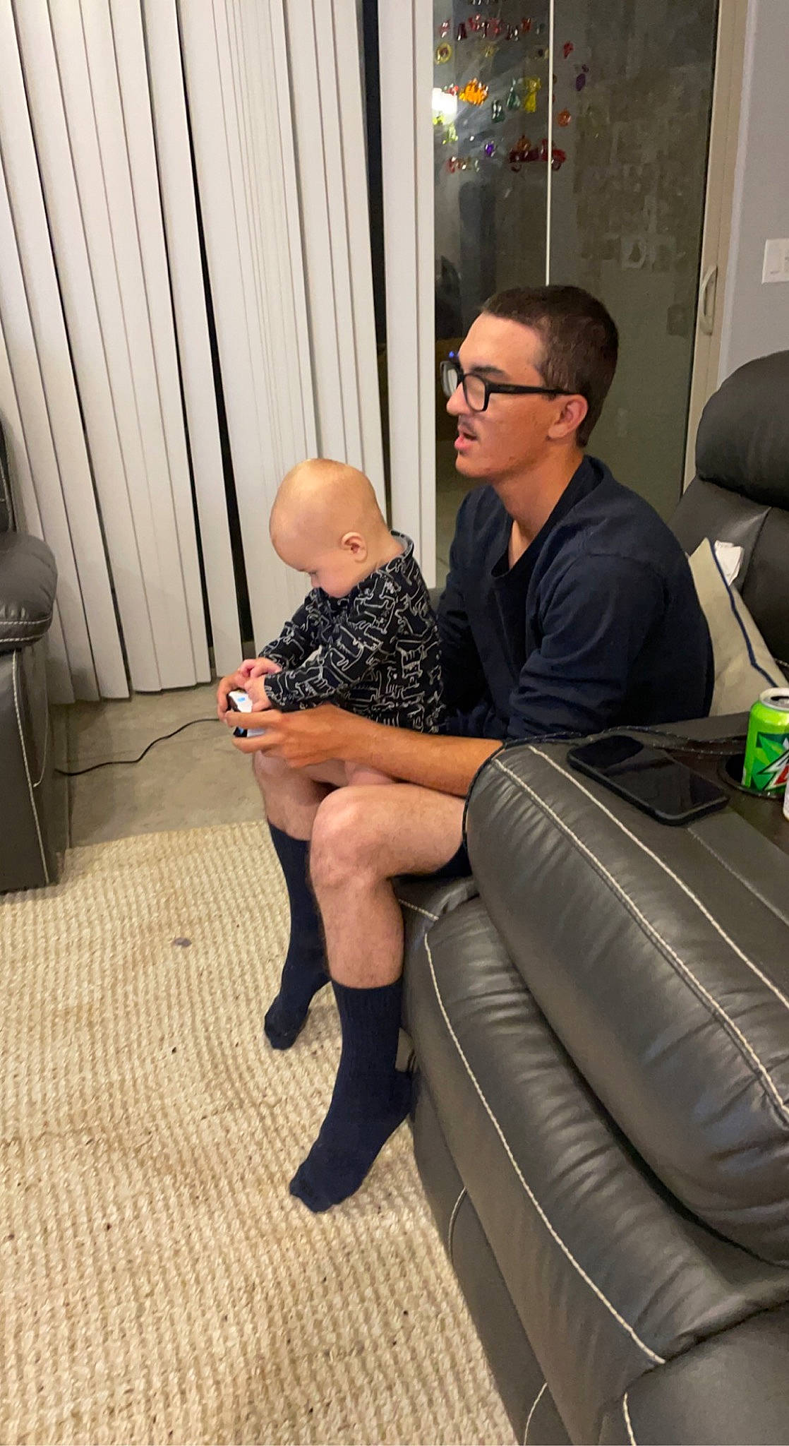 Colt joined the competition — help win amazing prizes! automotive_design, baby, comfort, curtain, event, eyewear, flooring, foot, glasses, human_leg, knee, lap, leather, leg, leisure, luxury_vehicle, person, shorts, sitting, sock