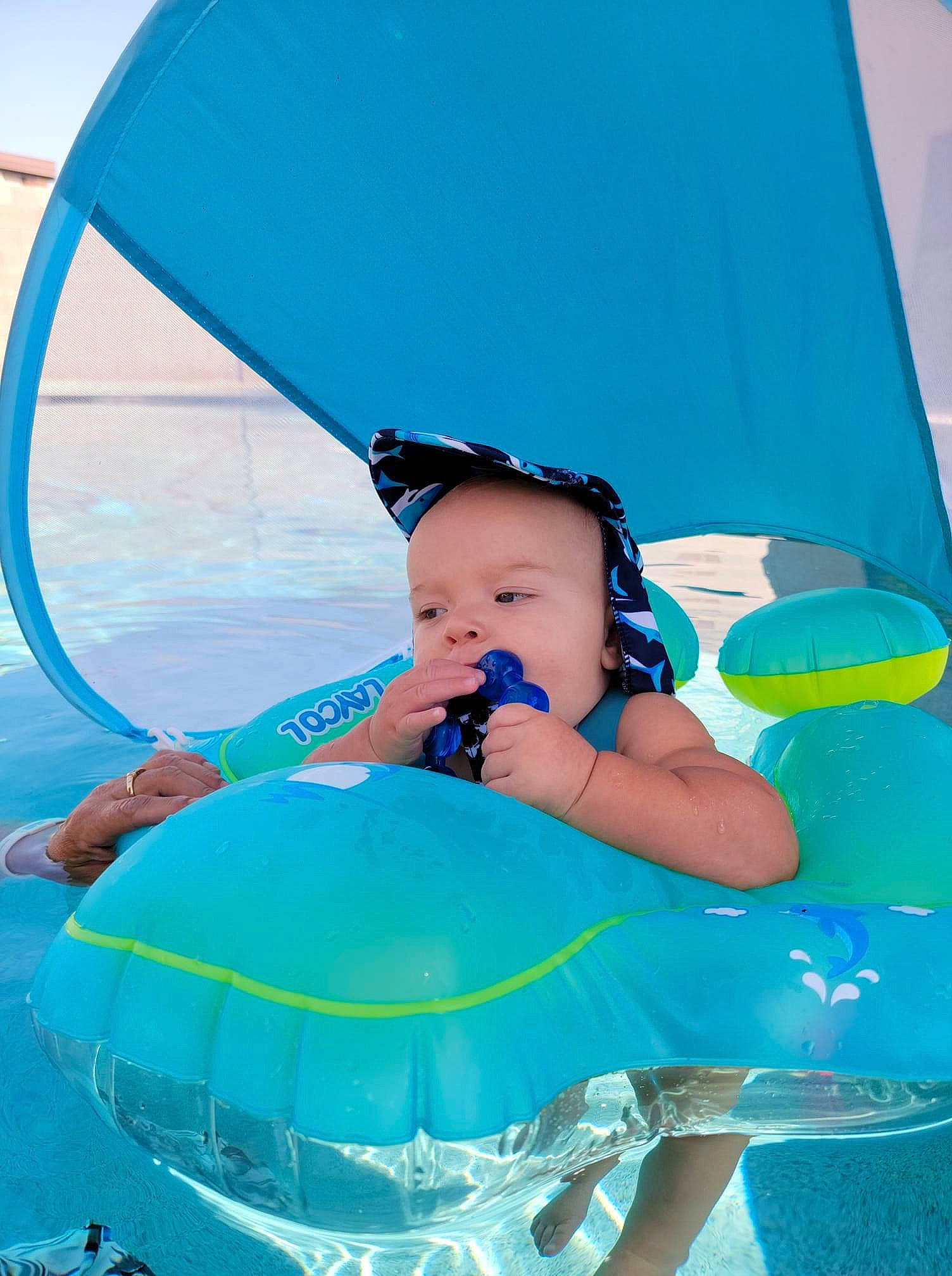 Colt is registered to the contest to win money with this photo: aqua, azure, baby, baby_products, baby_toddler_clothing, blue, child, electric_blue, event, fashion_accessory, fun, happy, hat, leisure, person, photograph, product, recreation, toddler, water