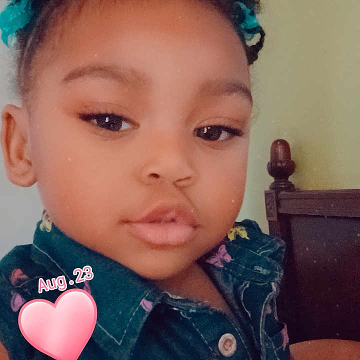 Lyric joined the competition — help win amazing prizes! baby, bodypart, clothing, coat, couch, face, finger, food, furniture, hand, happy, head, heart, jacket, person, photography, portrait, smile, sweets, symbol