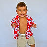 toddler, child, smiling, red_shirt, floral_pattern, shorts, standing, happy, cute, portrait, light_background, casual_clothing, european_skin_tone, short_hair, earrings, bare_chest, socks, white_shoes, playful, indoor