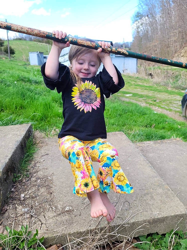 Harper joined the competition — help win amazing prizes! barefoot, child, fun, grass, happy, joy, leisure, pattern, people_in_nature, person, pink, plant, sitting, sky, sleeve, smile, spring, t_shirt, toddler, travel