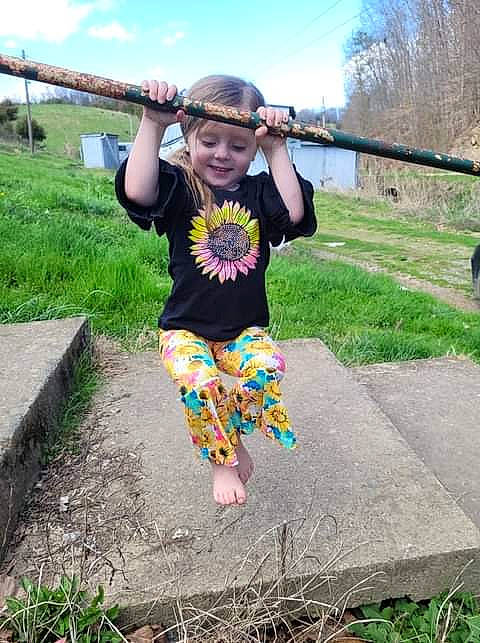 Harper is registered to the contest to win money with this photo: baby_toddler_clothing, barefoot, city, cloud, fun, grass, happy, headwear, joy, leisure, people_in_nature, person, plant, play, recreation, sitting, sky, smile, soil, t_shirt