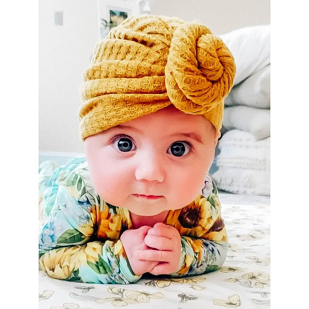 Maeve joined the competition — help win amazing prizes! baby, baby_toddler_clothing, cap, child, clothing, comfort, costume_hat, face, fashion_accessory, happy, hat, head, headgear, headwear, knit_cap, outerwear, pattern, person, sleeve, toddler