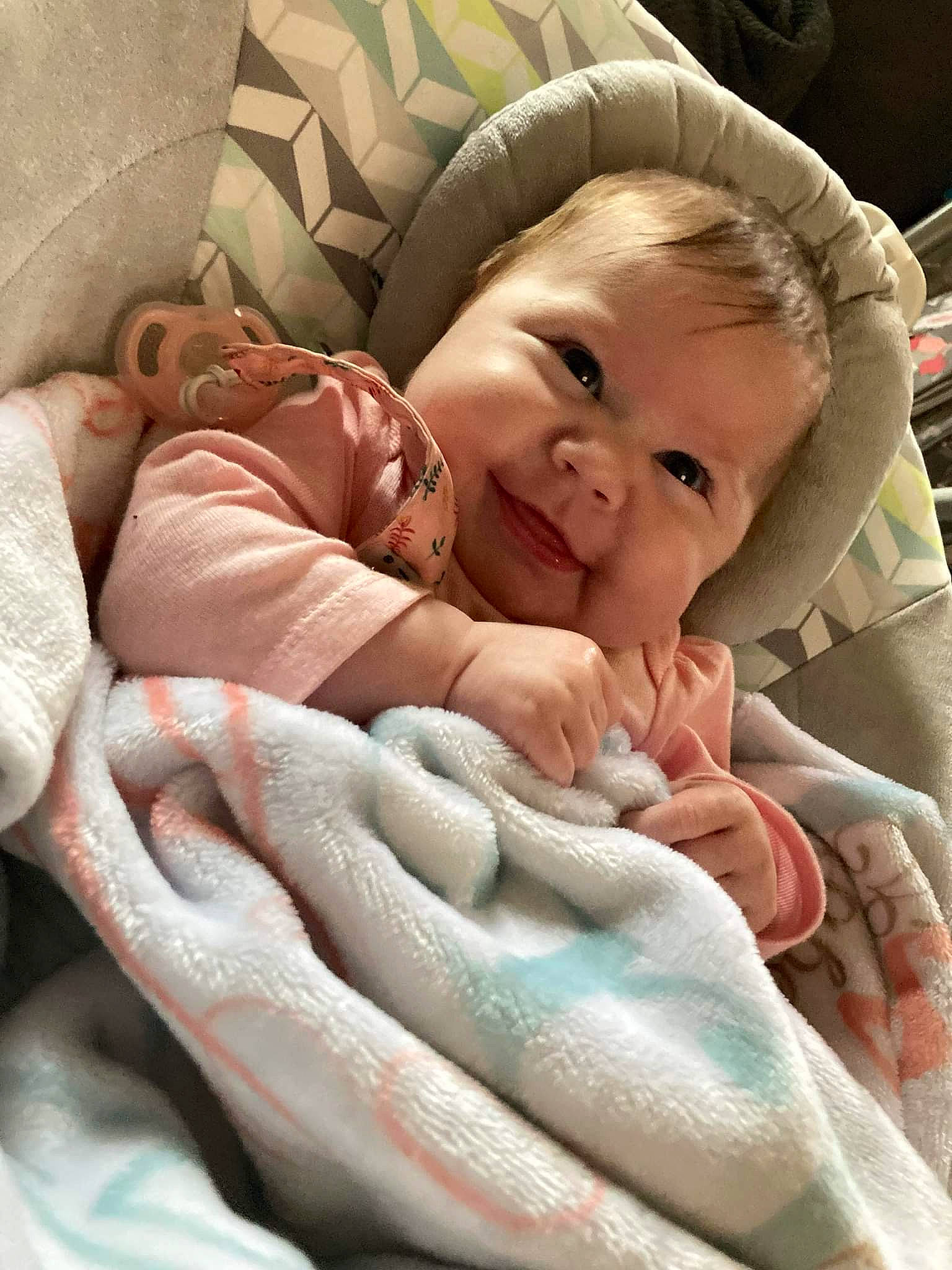 Averi is registered to the contest to win money with this photo: baby, baby_products, baby_sleeping, baby_toddler_clothing, car_seat, cheek, child, comfort, finger, gesture, happy, linens, nail, person, pink, product, room, skin, smile, thumb