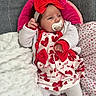 baby, infant, pacifier, red_bow, heart_pattern, white_clothing, blanket, bedding, soft_texture, cute, child, indoors, resting, headband, sock, lying_down, comfort, portrait, newborn, toddler