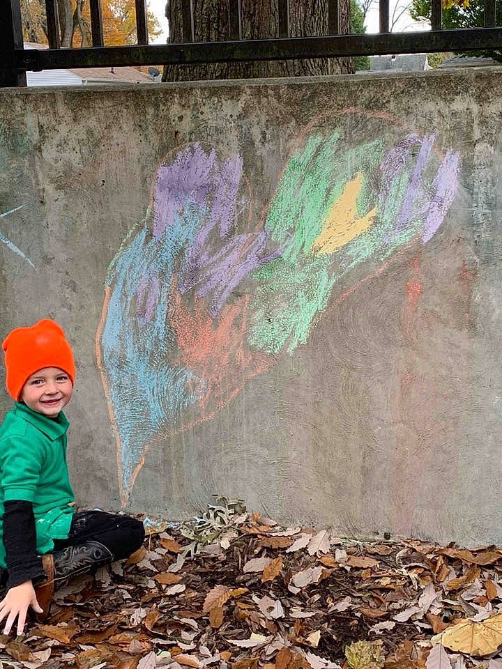 Colton is registered to the contest to win money with this photo: art, artist, asphalt, beauty, cap, graffiti, green, headwear, jacket, joy, leaf, line, mural, paint, person, photograph, road_surface, sidewalk, snapshot, tints_and_shades