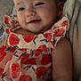 Lucifia joined the competition — help win amazing prizes! baby, child, smiling, dress, patterned_clothing, red, fruit_pattern, blanket, soft_texture, indoors, portrait, happy, cute, infant, person, closeup, relaxing, candid, comfort, young