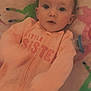 Lucifia joined the competition — help win amazing prizes! baby, infant, child, mohawk, blanket, colorful, soft_texture, clothing, peach_outfit, text_on_clothing, lying_down, wide_eyes, face, portrait, indoors, cute, young_child, pacifier, patterned_blanket, curious_expression