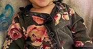 Lucifia is registered to the contest to win money with this photo: baby, blanket, child, clothing, comfort, cozy, cute, eyes, face, floral_pattern, hand, happy, indoors, infant, lying_down, mouth, pacifier, portrait, smiling, soft