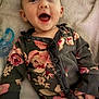 baby, blanket, child, clothing, comfort, cozy, cute, eyes, face, floral_pattern, hand, happy, indoors, infant, lying_down, mouth, pacifier, portrait, smiling, soft