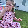 Everest Catherine Rose is registered to the contest to win money with this photo: blurred_background, cartoon_pattern, casual, child, cute, daylight, girl, grass, house, nature, outdoor, pink_dress, playtime, portrait, relaxed, sitting, strawberries, thoughtful, thumb_sucking, young