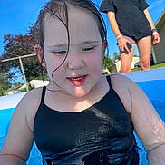Everest Catherine Rose is registered to the contest to win money with this photo: child, swimsuit, pool, water, summer, outdoor, sunny, blue_sky, wet_hair, person, playing, backyard, residential, fun, leisure, warm_weather, casual_clothing, shorts, bracelets, happy
