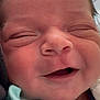 newborn, baby, face, closeup, smile, infant, skin, head, eyes_closed, mouth, cheeks, blanket, clothing, soft, cute, person, baby_clothes, newborn_baby, sleepy, happy