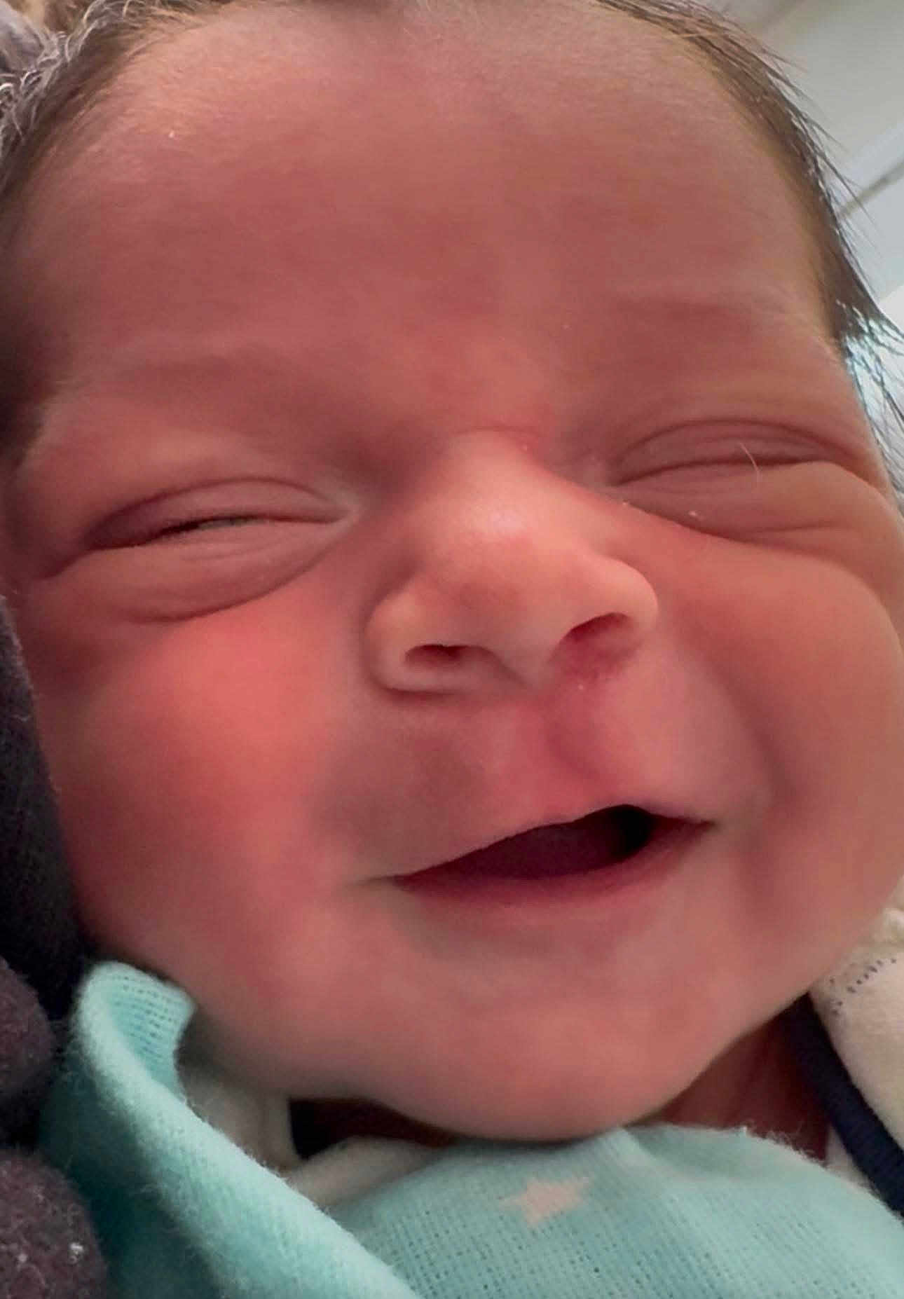 Mason joined the competition — help win amazing prizes! newborn, baby, face, closeup, smile, infant, skin, head, eyes_closed, mouth, cheeks, blanket, clothing, soft, cute, person, baby_clothes, newborn_baby, sleepy, happy