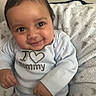 Mason joined the competition — help win amazing prizes! baby, infant, child, smiling, onesie, clothing, blanket, soft_texture, indoor, cute, happy, portrait, face, hands, seated, young_child, expression, cozy, warm, love