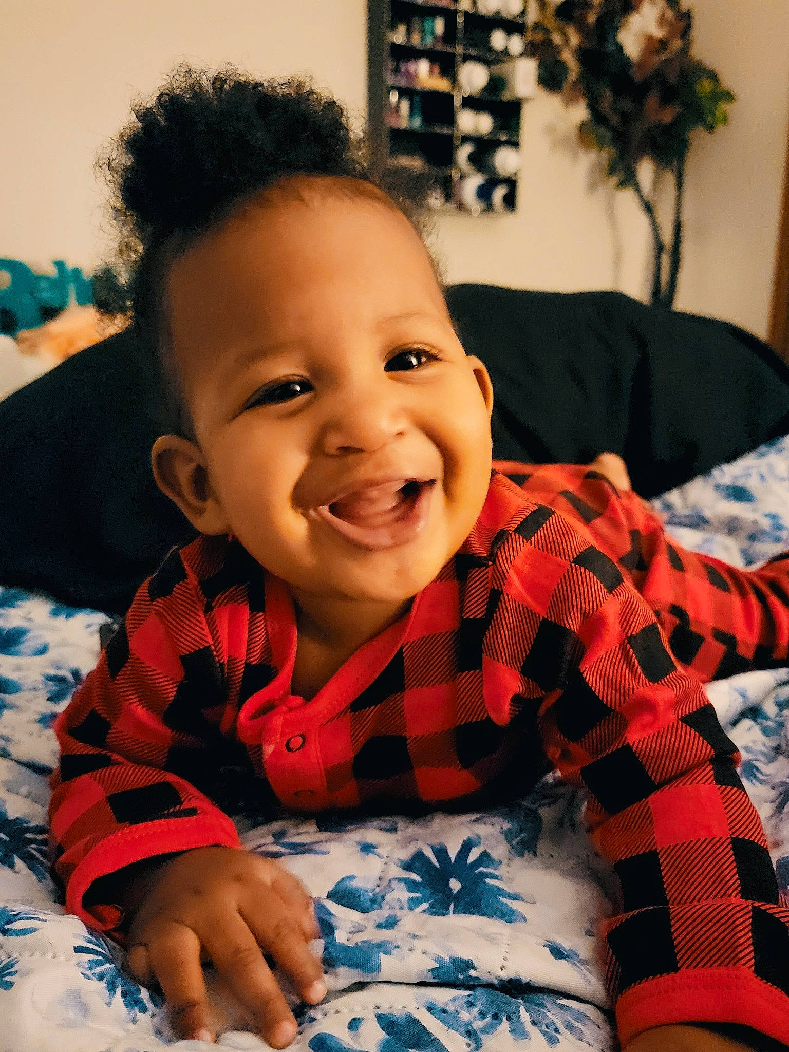Azaiah is registered to the contest to win money with this photo: arm, baby, baby_toddler_clothing, cheek, child, chin, comfort, happy, houseplant, iris, joy, mouth, nose, pattern, person, plaid, skin, sleeve, smile, tartan