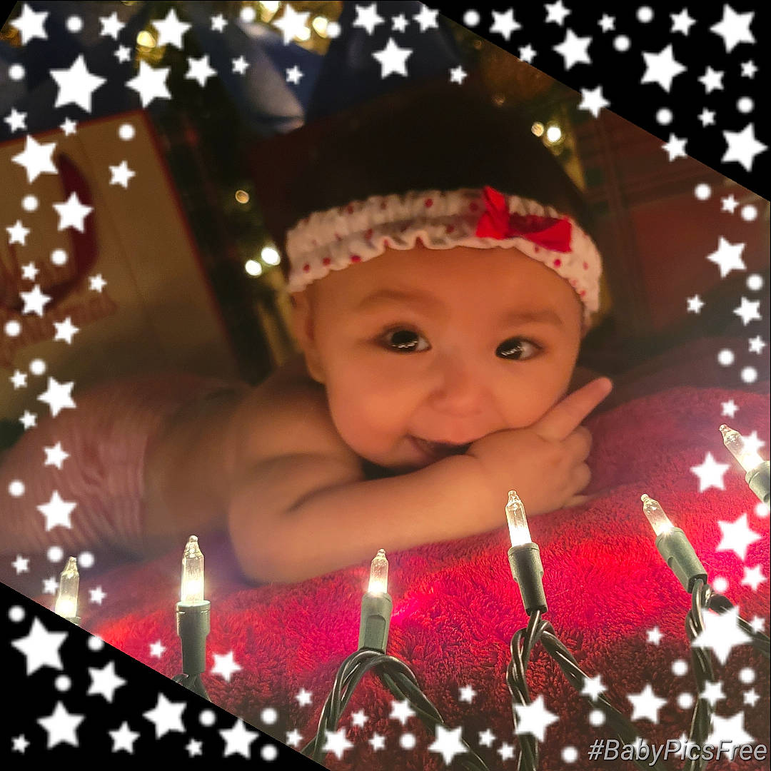 Edan joined the competition — help win amazing prizes! baby, beauty, birthday, candle, christmas, christmas_decoration, christmas_eve, christmas_ornament, costume_hat, event, fun, happy, headwear, holiday, interior_design, magenta, ornament, person, pink, smile