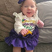 Gioella joined the competition — help win amazing prizes! baby, infant, smiling, headband, bow, purple_skirt, ruffle_skirt, onesie, couch, pillow, blanket, cozy, hands, legs, socks, portrait, cute, home_interior, happy, baby_clothing