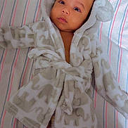 Antoneil joined the competition — help win amazing prizes! adorable, baby, blanket, child, clothing, cute, diaper, elephant_pattern, feet, hood, indoor, infant, lying_down, mesh_sides, portrait, robe, sleeping_area, soft_fabric, striped, toes