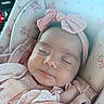 baby, infant, sleeping, pink, headband, bow, car_seat, floral_pattern, clothing, cute, child, face, peaceful, knitwear, closeup, portrait, skin, soft_light, indoors, resting