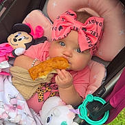 Ellie Bea is registered to the contest to win money with this photo: baby, stroller, bow, bread, plush_toy, unicorn, minnie_mouse, blanket, pink, blue_eyes, outdoor, grass, cute, infant, child, bracelet, toy, snack, cozy, headband