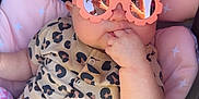 Ellie Bea is registered to the contest to win money with this photo: baby, infant, sunglasses, pink, leopard_print, onesie, seat, car_seat, child, cute, hand, fingers, reflection, pattern, clothing, portrait, babywear, comfort, sunny, stylish