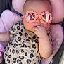baby, infant, sunglasses, pink, leopard_print, onesie, seat, car_seat, child, cute, hand, fingers, reflection, pattern, clothing, portrait, babywear, comfort, sunny, stylish