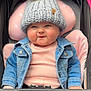 baby, child, chubby_cheeks, clothing, cozy, cute, denim_jacket, face, fashion, headwear, infant, knit_hat, person, pink_cushion, pom_pom, portrait, seat, smile, stroller, warm_clothes