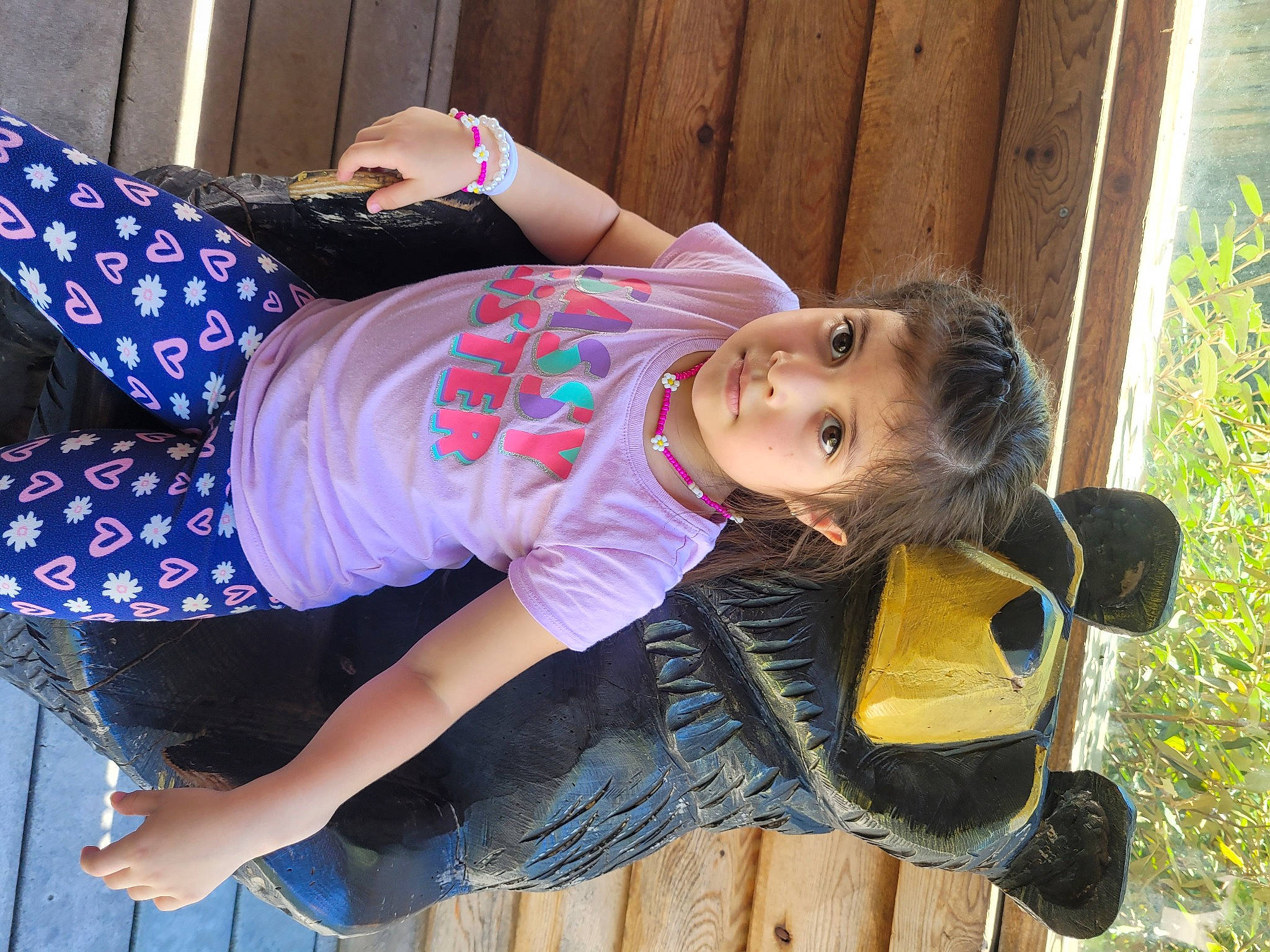 Danna is registered to the contest to win money with this photo: child, cool, denim, eyewear, fun, grass, happy, hat, human_leg, leisure, pattern, person, plant, shoe, sitting, sleeve, sunglasses, t_shirt, thigh, toddler