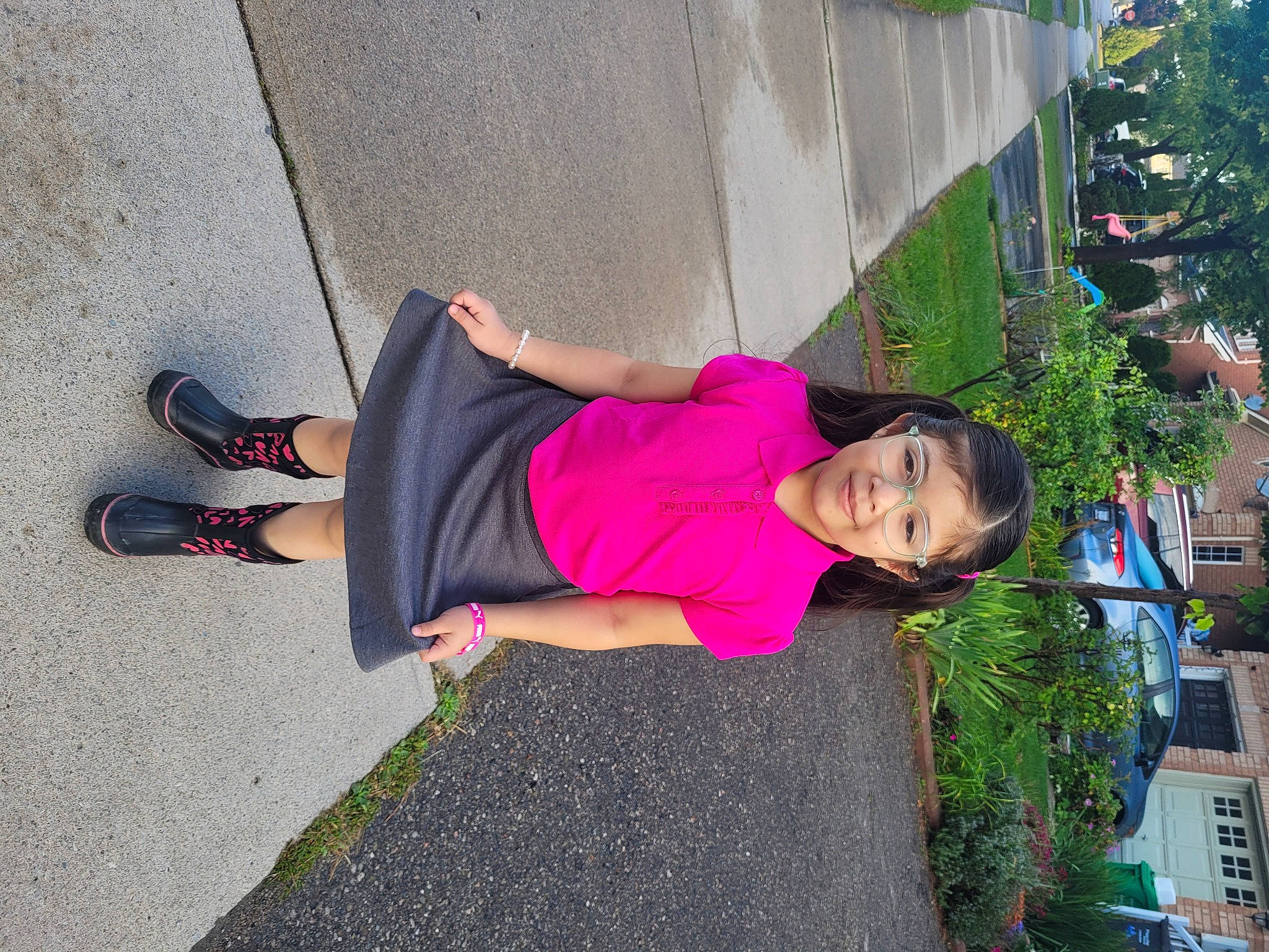 Danna joined the competition — help win amazing prizes! asphalt, fun, grass, human_leg, joy, knee, leisure, magenta, pedestrian, person, plant, recreation, road, road_surface, shadow, shrub, sidewalk, sitting, street, thigh