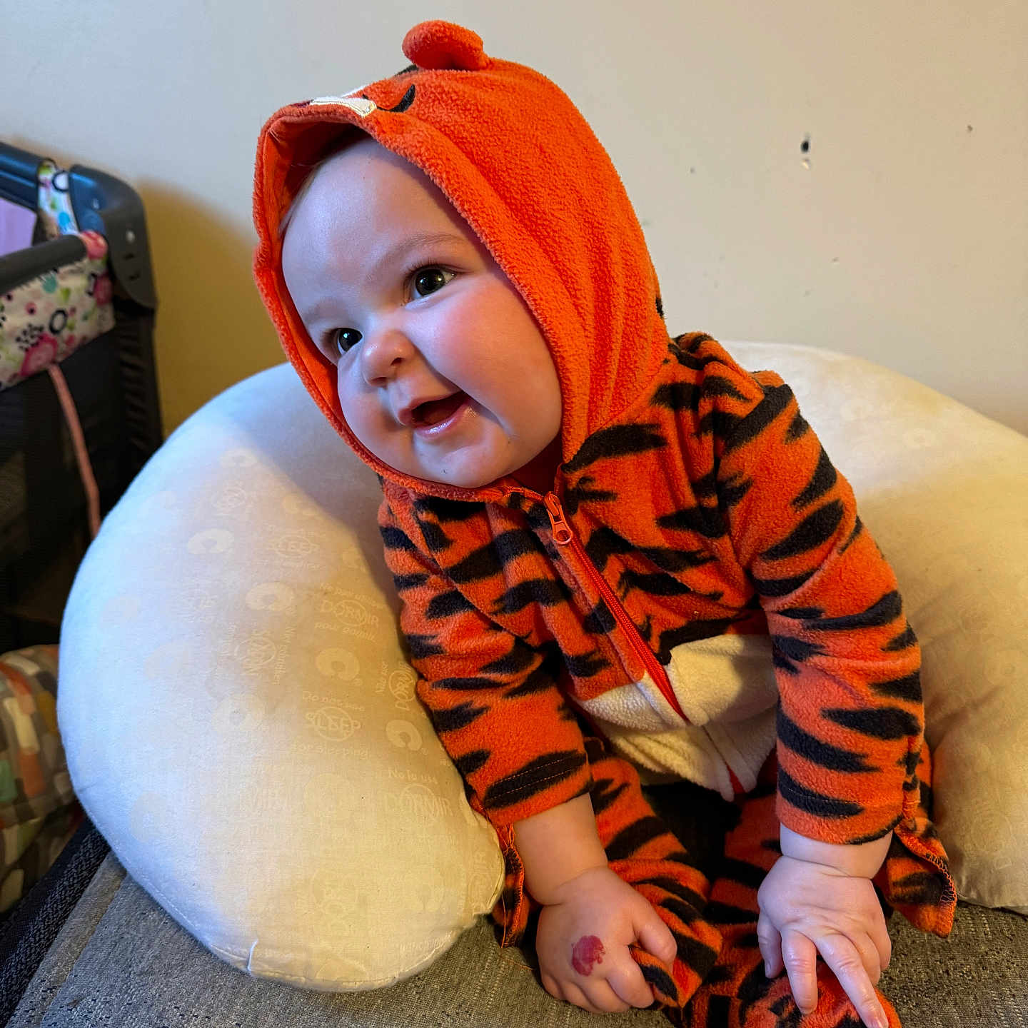 Jewely joined the competition — help win amazing prizes! baby, black_stripes, child, clothing, couch, cute, eyes, face, hand, happy, hooded_clothing, indoor, infant, orange, pillow, plush, sitting, smiling, soft_texture, tiger_onesie
