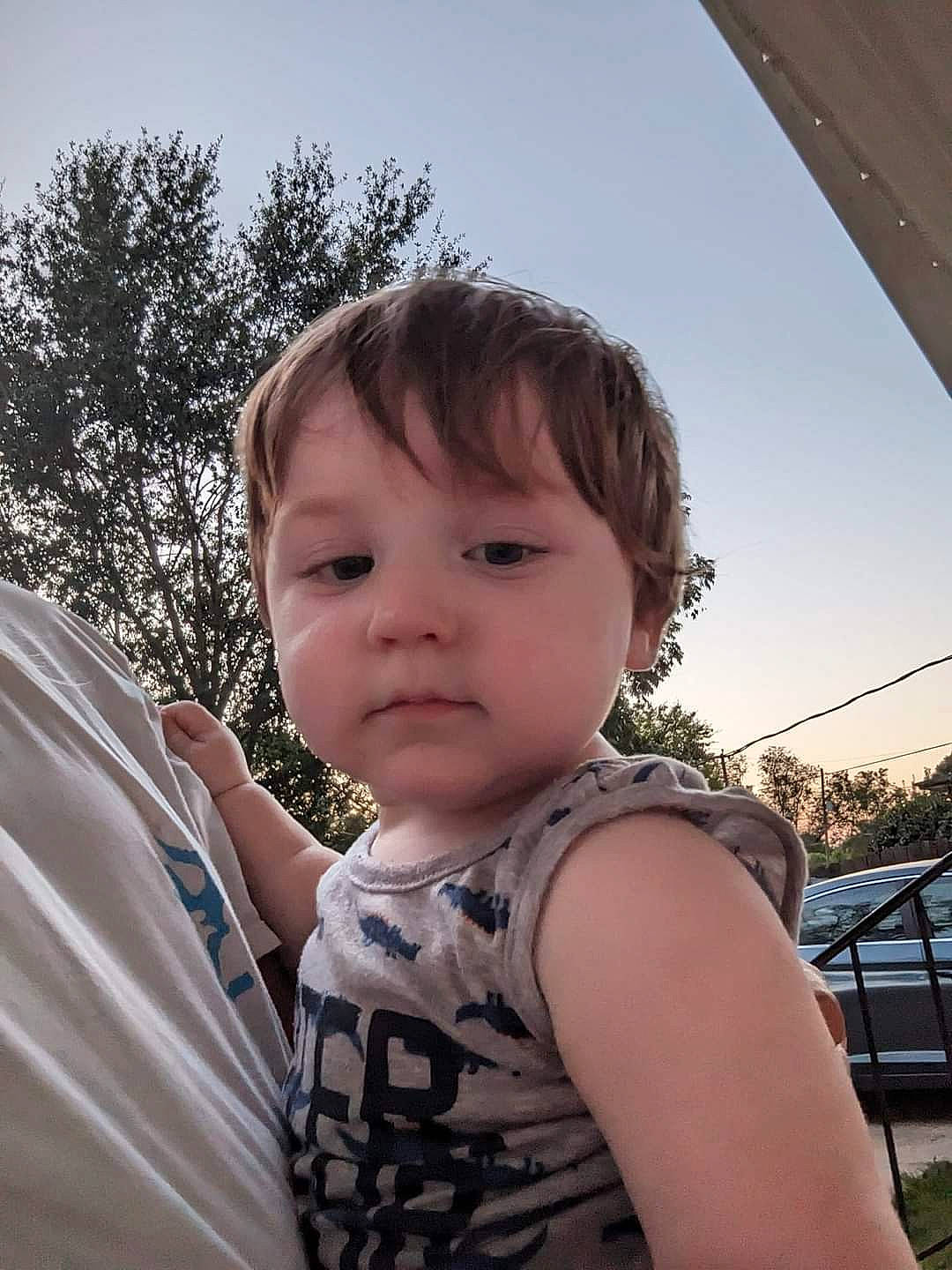 Austin is registered to the contest to win money with this photo: baby, blond, child, cool, eyelash, eyewear, facial_expression, fun, grass, happy, head, human_body, leisure, lip, nose, person, sky, t_shirt, toddler, tree