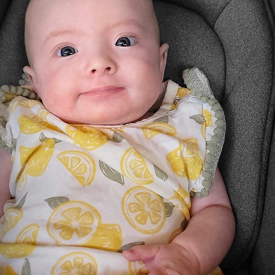 Nicole is registered to the contest to win money with this photo: baby, bodypart, chair, clothing, couch, cushion, face, finger, furniture, hand, happy, hat, head, homedecor, newborn, person, photography, portrait, sitting, smile