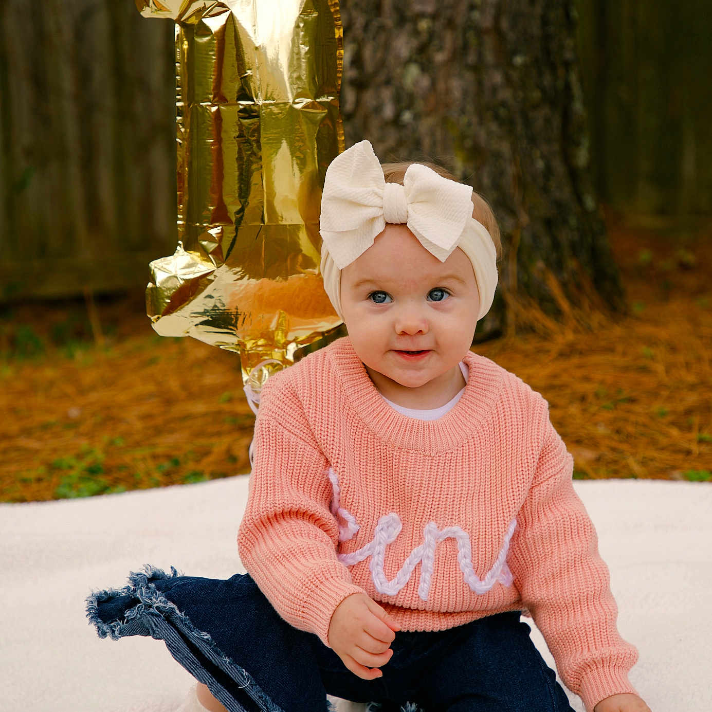 Kensleigh Grace joined the competition — help win amazing prizes! baby, balloon, blanket, bow, celebration, child, cute, first_birthday, girl, headband, jeans, number_one, outdoor, pine_needles, pink, plate, portrait, smile, sweater, tree