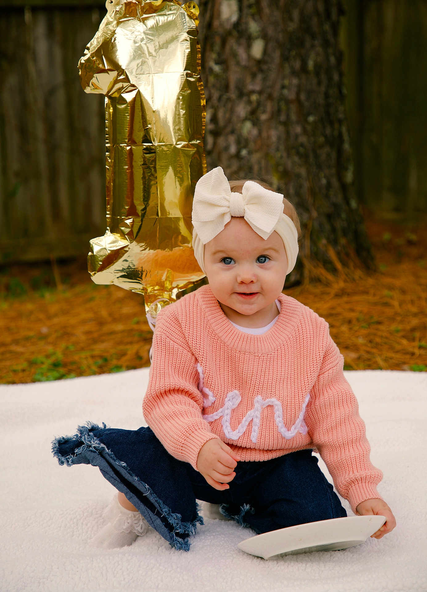 Kensleigh Grace joined the competition — help win amazing prizes! baby, child, girl, bow, headband, sweater, pink, jeans, plate, balloon, number_one, outdoor, tree, pine_needles, blanket, smile, celebration, first_birthday, cute, portrait