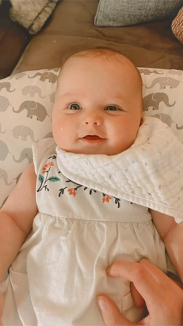 Saylor is registered to the contest to win money with this photo: baby, baby_toddler_clothing, cheek, child, chin, collar, comfort, facial_expression, iris, linens, lip, mouth, nose, person, product, sitting, skin, sleeve, smile, textile