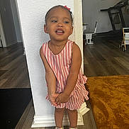 Nayana joined the competition — help win amazing prizes! child, girl, dress, striped, pink, shoes, sneakers, standing, indoor, floor, carpet, wall, expression, playful, hair_bow, furniture, treadmill, home, person, smile