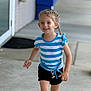 Paisley is registered to the contest to win money with this photo: child, girl, smiling, braided_hair, striped_shirt, shorts, running, outdoor, sidewalk, happy, face_paint, casual_clothing, daylight, young, playful, cheerful, person, feet, expression, motion