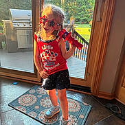 Paisley joined the competition — help win amazing prizes! child, girl, sunglasses, red, toy, microphone, shorts, sneakers, rug, door, glass, backyard, sunlight, indoor, floor, pattern, playful, summer, casual, happy
