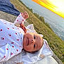 Milaya participe au concours pour gagner de l'argent avec cette photo : baby, infant, blanket, outdoor, sunset, nature, grass, sky, face, clothing, peaceful, lying_down, portrait, cute, child, scenery, relaxation, warm_light, soft_texture, daylight