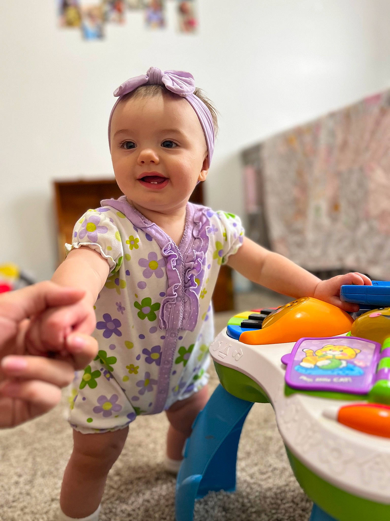 Raelynn is registered to the contest to win money with this photo: baby, baby_playing_with_toys, baby_toddler_clothing, child, facial_expression, fun, hand, happy, leisure, people, person, photograph, purple, recreation, skin, sleeve, smile, snapshot, table, toddler