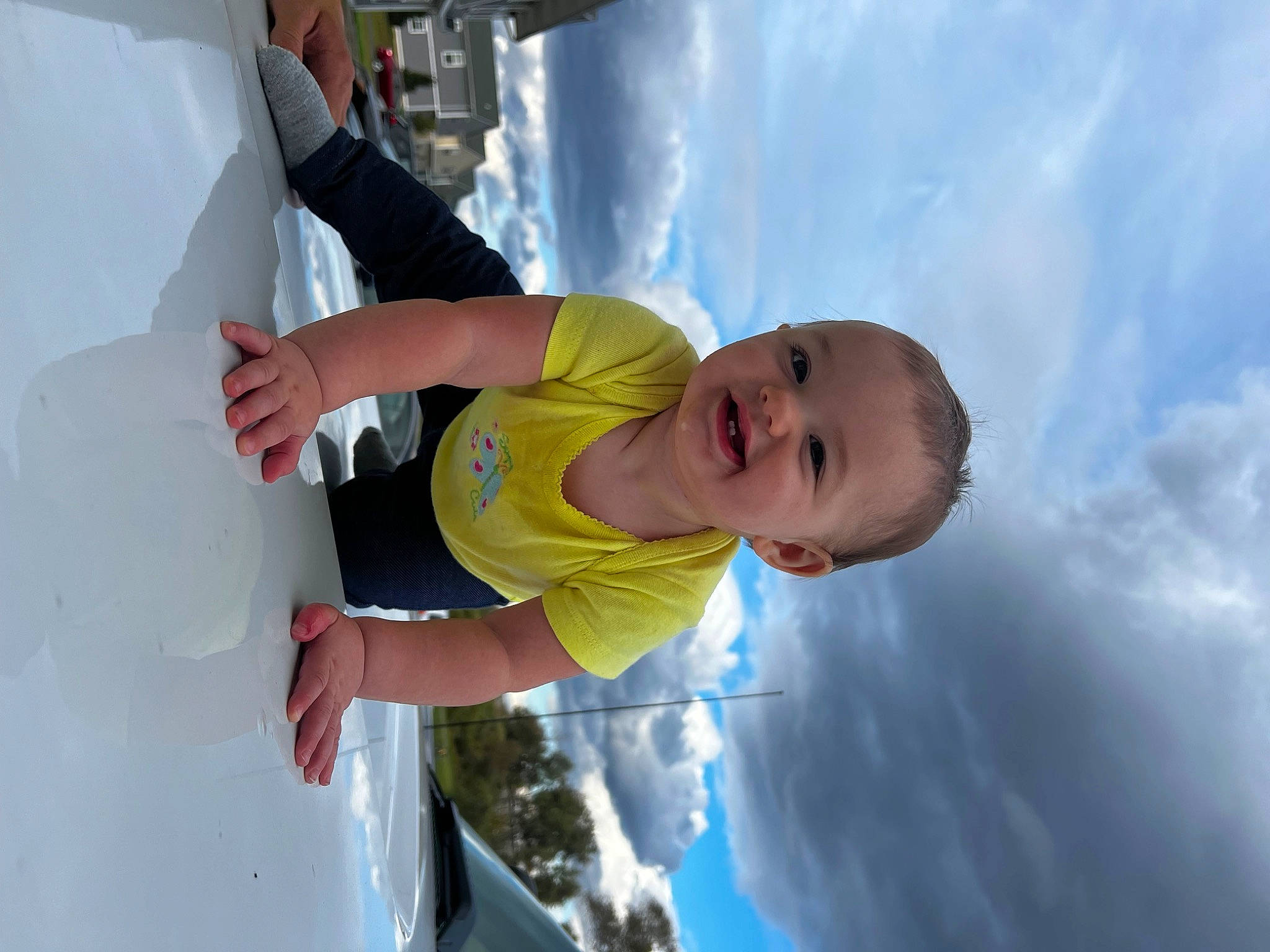 Raelynn joined the competition — help win amazing prizes! azure, baby, child, cloud, cumulus, daytime, elbow, electric_blue, fun, gesture, happy, joy, leisure, person, recreation, sky, smile, summer, t_shirt, toddler