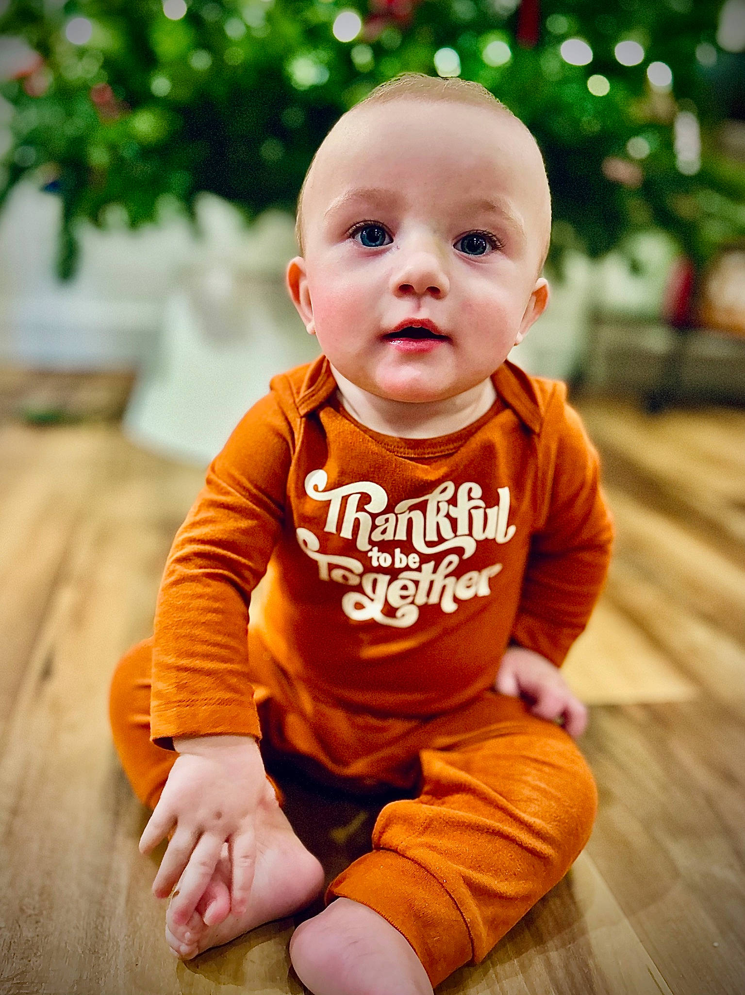 Zayden joined the competition — help win amazing prizes! baby, baby_toddler_clothing, cheek, child, flooring, fun, grass, happy, hardwood, orange, people_in_nature, person, portrait_photography, shorts, sitting, skin, sleeve, smile, t_shirt, toddler