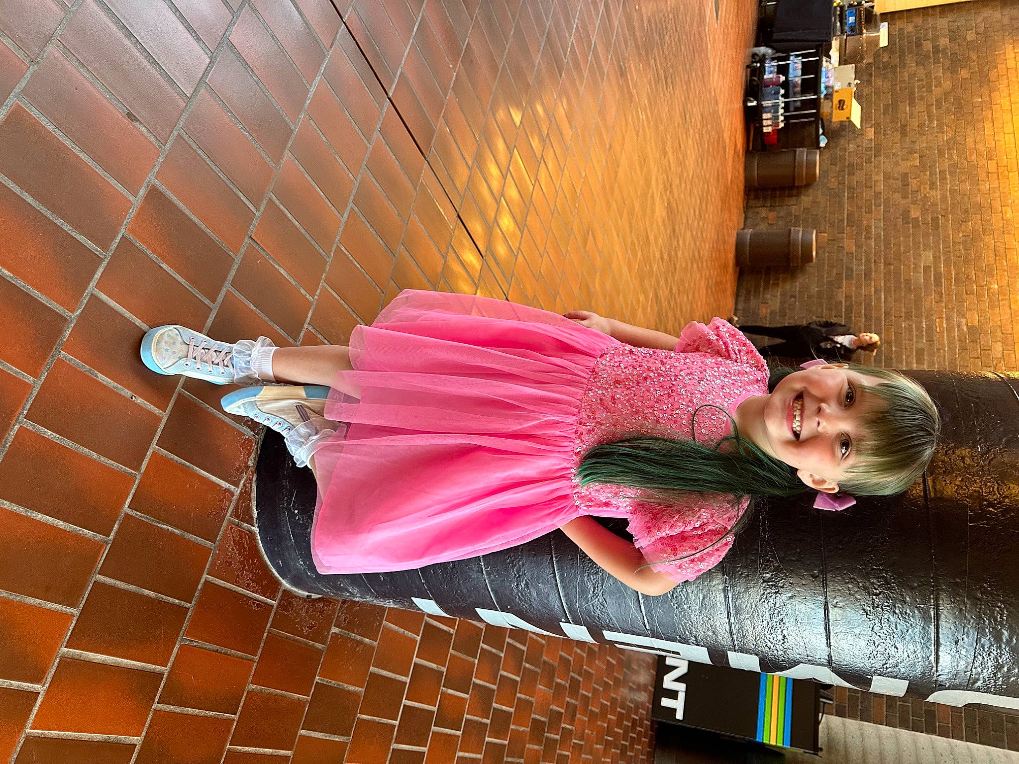 Jaiyda joined the competition — help win amazing prizes! brick, child, dress, fashion_design, fun, happy, human_leg, joy, leisure, line, magenta, peach, person, pink, red, sitting, tire, toddler, wall, wheel