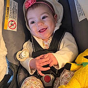 Sky is registered to the contest to win money with this photo: baby, baby_shoes, blanket, bright_eyes, car_seat, cheeks, cute, floral_clothing, flower_accessory, hands, headband, hood, indoor, infant, pacifier, plush_toy, portrait, safety_harness, smiling, warning_label