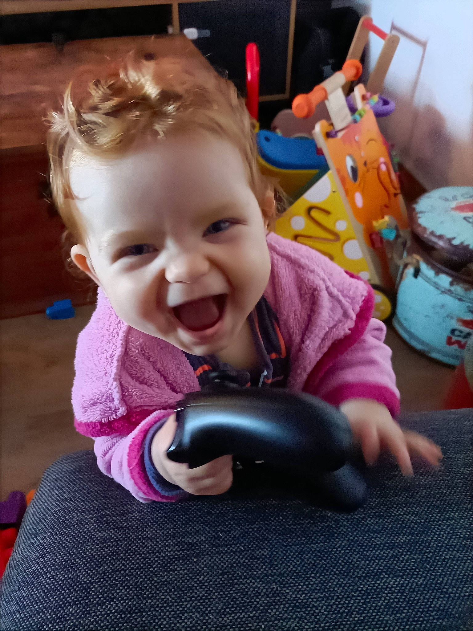 Lyne participe au concours pour gagner de l'argent avec cette photo : audio_equipment, baby, baby_toddler_clothing, cheek, ear, face, facial_expression, fun, gadget, happy, human_body, magenta, mouth, nose, organ, person, pink, purple, skin, smile